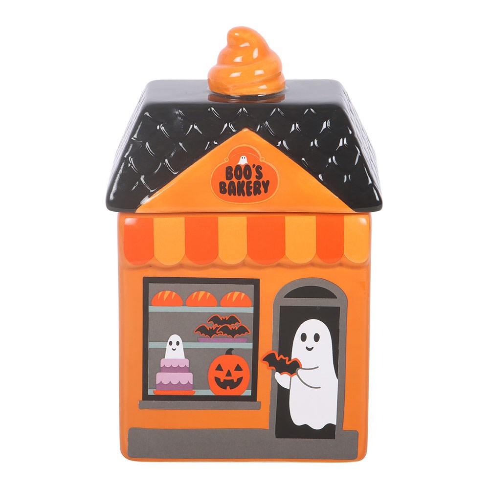 Halloween-themed candy house wax melt and oil burner with pumpkins and ghost decorations on a white background