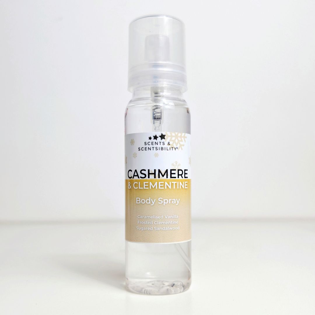 A bottle of body spray with a gold label saying Cashmere & Clementine