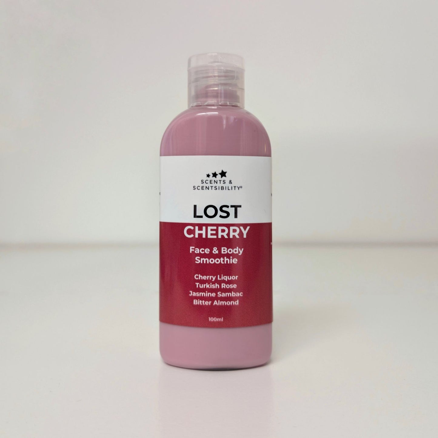 Bottle of 'Lost Cherry' face and body smoothie with a white label on a light grey background