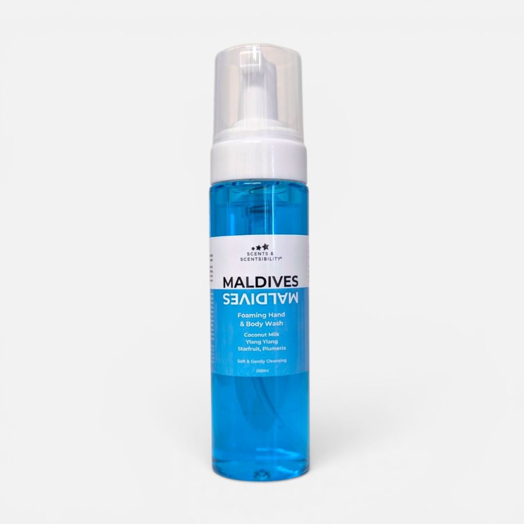 A bottle of Maldives Foaming Hand & Body Wash with bright blue liquid soap, a white pump dispenser, and a white label, set against a plain light gray background.