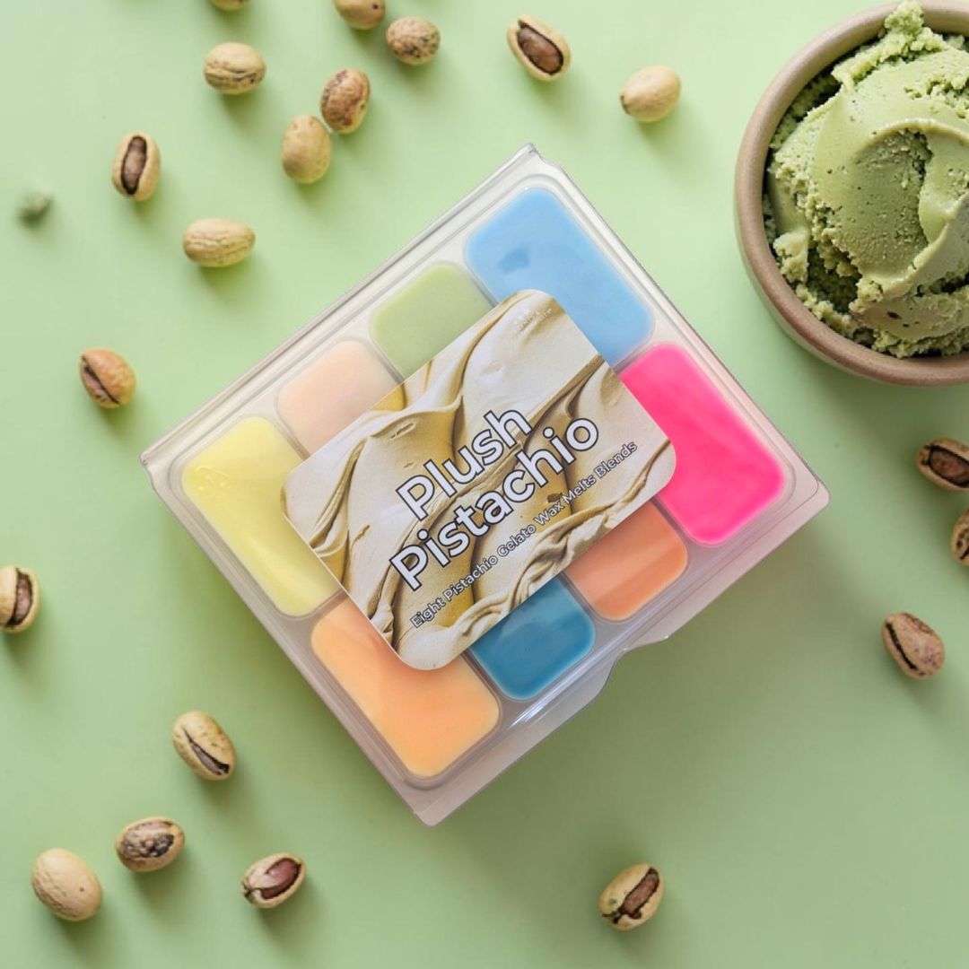 Set of colorful wax melts in a clear container with 'Plush Pistachio' branding on a green background with pistachios and ice cream
