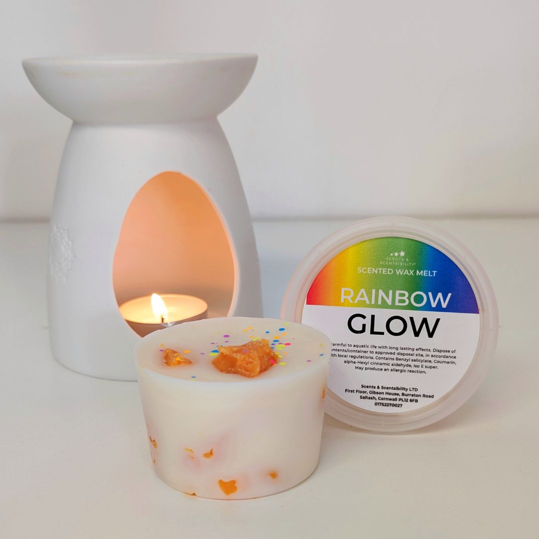 Candle, wax melt, and warmer with 'Rainbow Glow' label on a white background