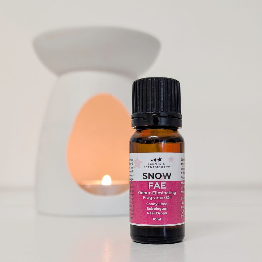 Bottle of 'Snow FAE' fragrance oil with a diffuser in the background