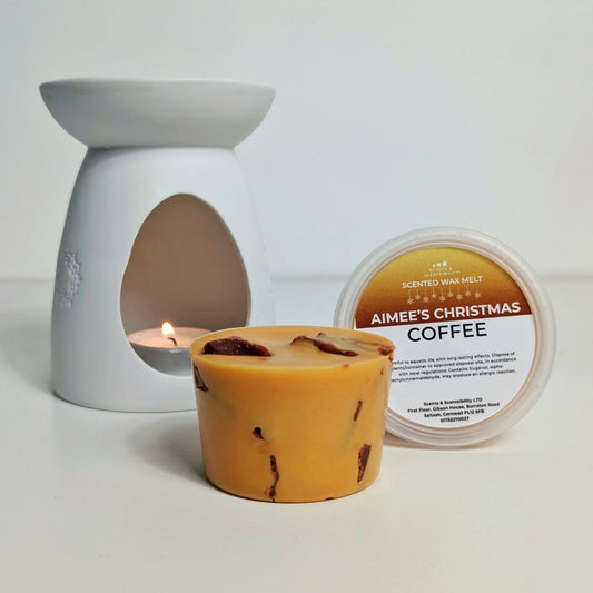 Scented wax melt container labeled 'Aimee's Christmas Coffee' with a wax melt and wax melt burner on a light background