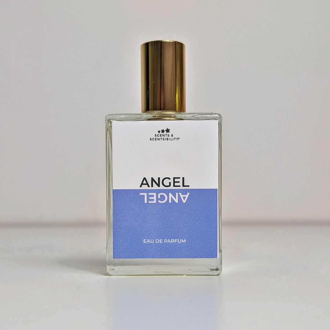 A bottle of perfume in a glass bottle with gold cap and a blue and white label saying 'Angel'