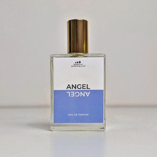 A bottle of perfume in a glass bottle with gold cap and a blue and white label saying 'Angel'