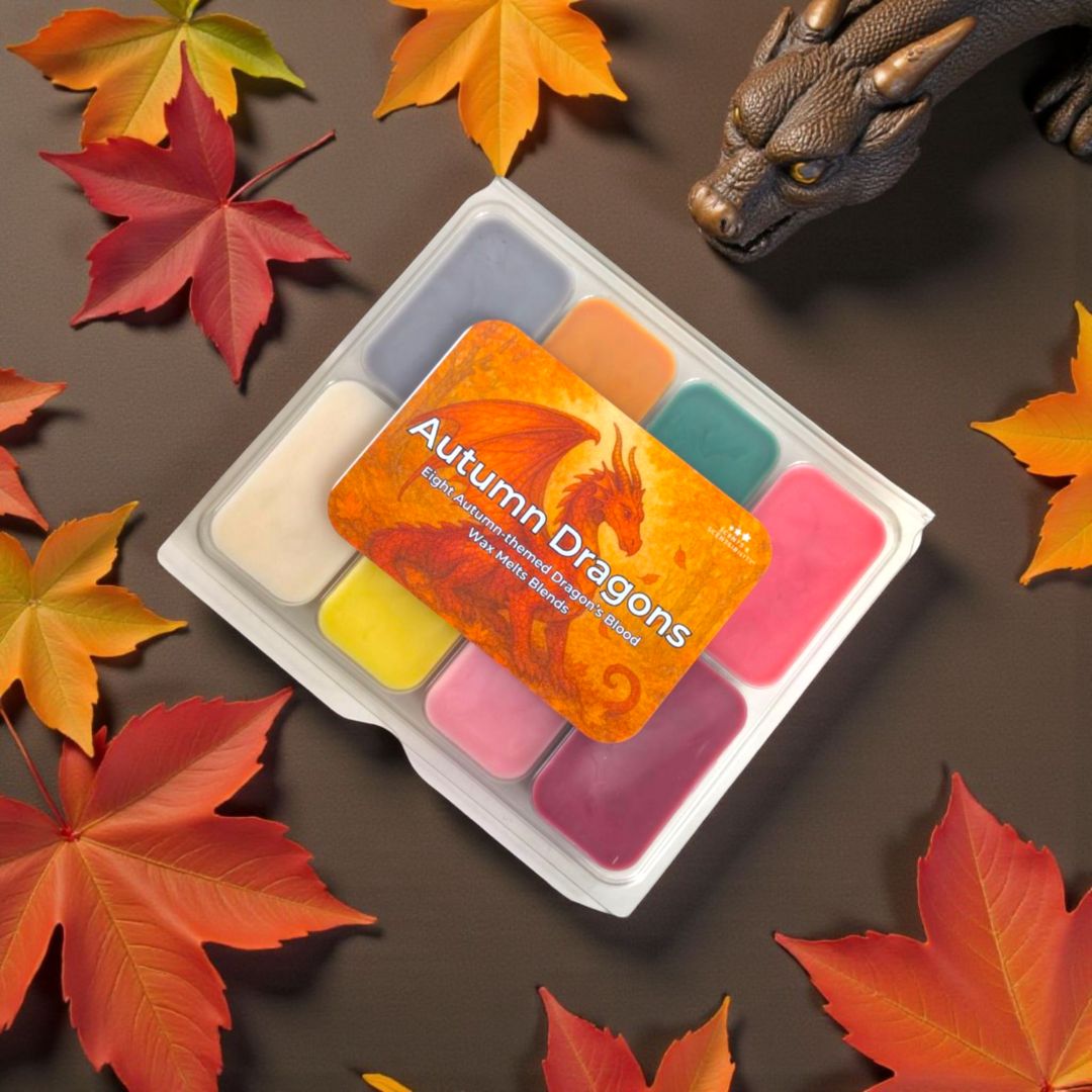 Set of wax melts with 'Autumn Dragons' packaging surrounded by autumn leaves on a brown background