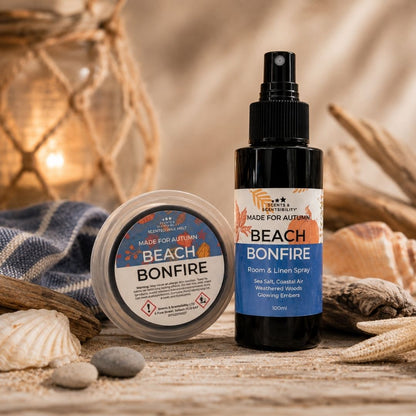 Made For Autumn Beach Bonfire Room & Linen Spray and scented wax melt styled together in a cosy coastal autumn setting with rustic wood and subtle seaside-inspired details.