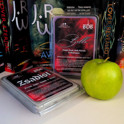 Wax melts labeled 'Bella' and 'Zsadist' with an apple on a surface