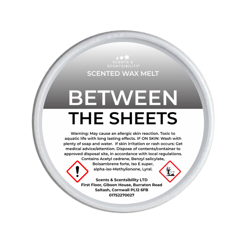Scented wax melt container labeled 'Between the Sheets' with warning information on a green background