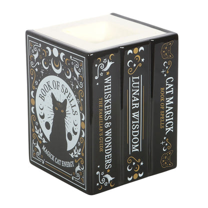 Decorative book shaped cat-themed wax melt and oil burner on a white background