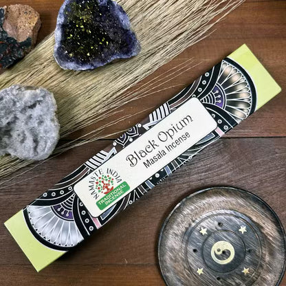 Box of Black Opium Masala Incense with decorative elements on a wooden surface