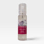 A spray bottle with a dark red and white label saying Black Raspberry & Vanilla