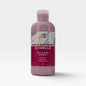 A 100ml plastic bottle of Scents & Scentsibility Face & Body Smoothie in Black Raspberry & Vanilla scent, filled with a dusty purple liquid, set against a light gray background.