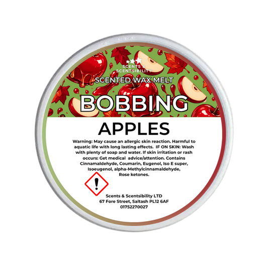 A round tub of Scents & Scentsibility Scented Wax Melt in the 'Bobbing Apples' fragrance, featuring a green and red apple-patterned label with a white warning panel at the bottom.