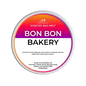 A Scents & Sensibility 'Bon Bon Bakery' scented wax melt, featuring a colorful gradient label with orange, pink, and purple hues on a solid dark green background.