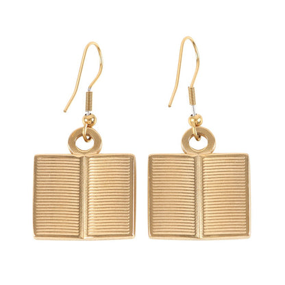 Gold book-shaped earrings on a white background