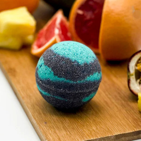 Bath bomb on a wooden board with fruits in the background