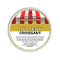 A round metal tub of Scents & Scentsibility 'Buttery Croissant' scented wax melt by Barrie's Bakehouse, featuring a label with red and white striped bakery awnings and yellow and white text.