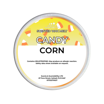 A round tin of Scents & Scentsibility 'Candy Corn' scented wax melt, featuring a yellow and white label with candy corn illustrations, on a solid white background.
