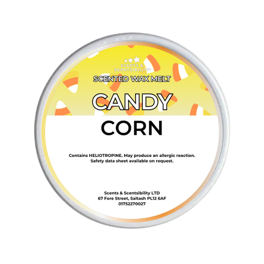 A round tin of Scents & Scentsibility 'Candy Corn' scented wax melt, featuring a yellow and white label with candy corn illustrations, on a solid white background.