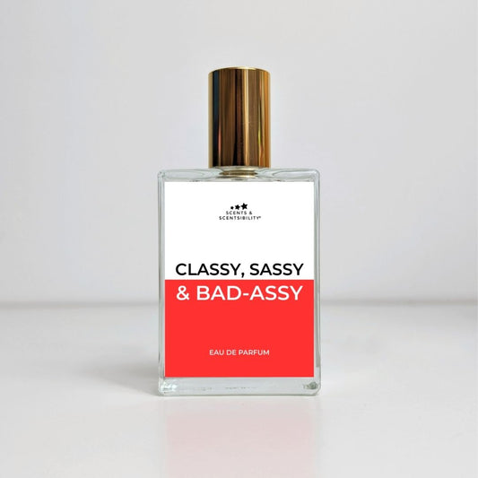 A perfume bottle with gold lid and a red and white label saying Classy, Sassy & Badassy Eau De Parfum