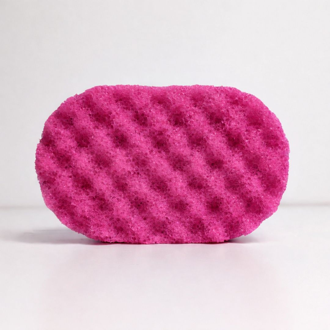 Dark pink purple soap sponge on a white background