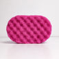 Dark pink purple soap sponge on a white background