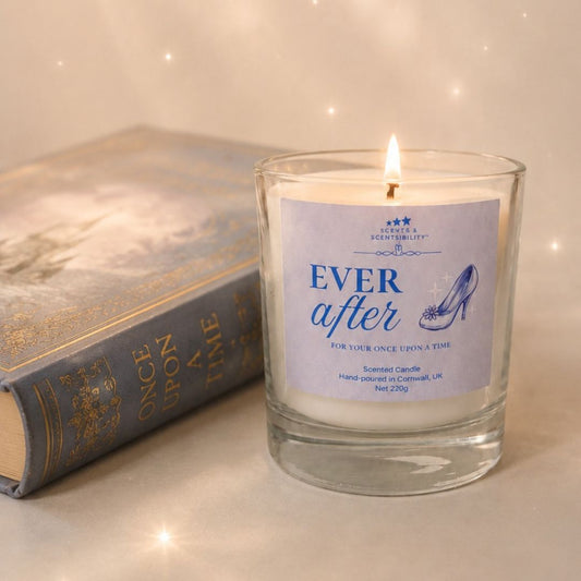Candle labeled 'Ever After' next to a book titled 'Once Upon a Time' on a soft background