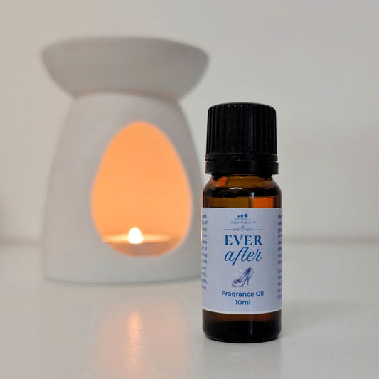 Bottle of 'Ever After' fragrance oil with a lit wax warmer in the background