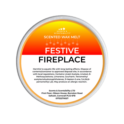 Scented wax melt container with 'Festive Fireplace' label on a green background