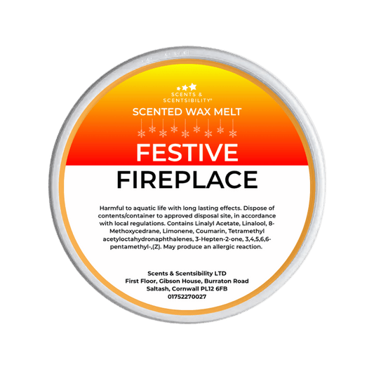 Scented wax melt container with 'Festive Fireplace' label on a green background