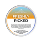 A  Scents & Scentsibility Freshly Picked Scented Wax Melt, featuring a white label with orange and blue gradient accents, set against a solid dark green background.