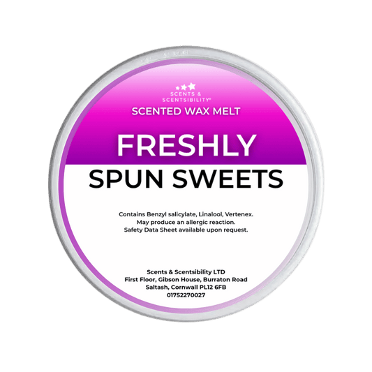Scented wax melt container labeled 'Freshly Spun Sweets' on a green background