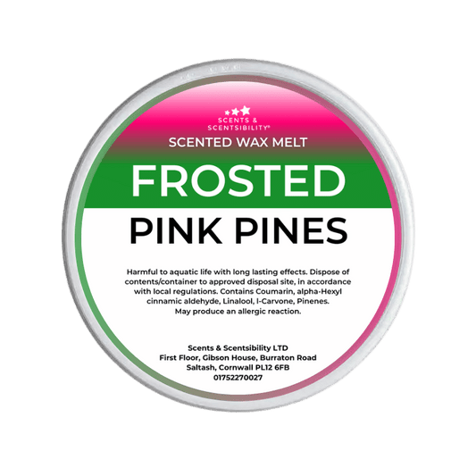 Scented wax melt container labeled 'Frosted Pink Pines' on a green background