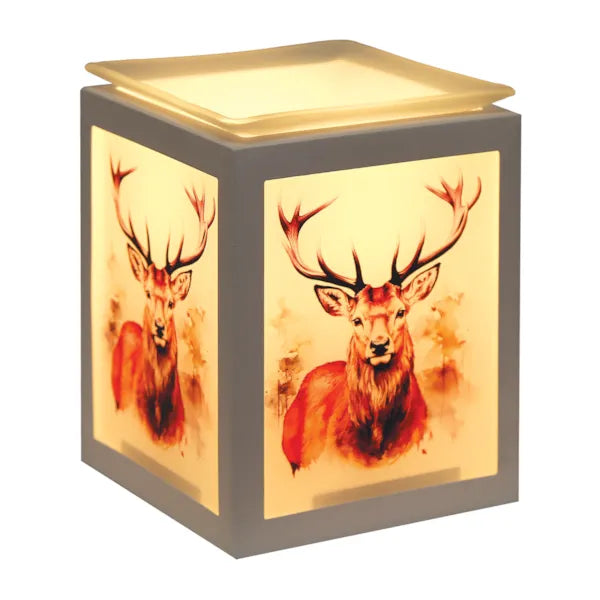 A cube-shaped decorative wax melt warmer with a white frame and warm illuminated panels, featuring printed watercolor-style deer artwork on the front and side.