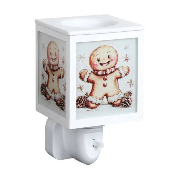 A white plug in wax melt warmer, featuring a festive gingerbread man design