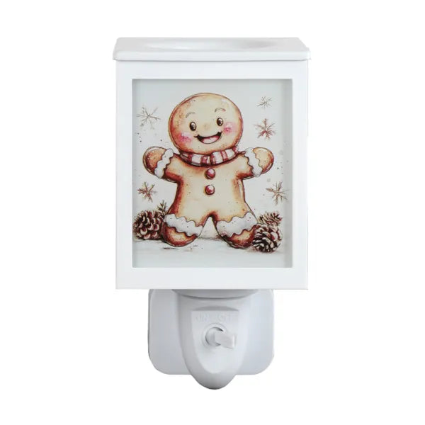 A white Christmas-themed wax melt warmer with a square front panel featuring a smiling gingerbread man illustration, set against a plain white background.