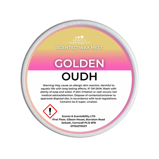 Scented wax melt container labeled 'Golden Oudh' with warning information on a green background