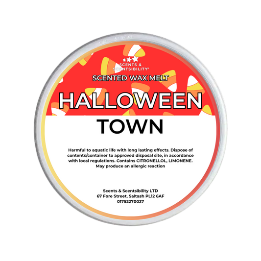 A round tub of Scents & Scentsibility 'Halloween Town' scented wax melt, featuring a red, white, and orange label with candy graphics.