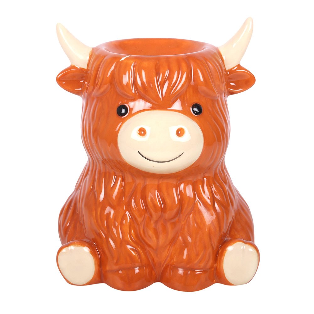 Front view of the Highland Cow Ceramic Wax Melt and Oil Burner featuring shaggy ginger fur, cream horns, black eyes, a smiling muzzle and little cream hooves.