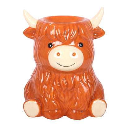 Front view of the Highland Cow Ceramic Wax Melt and Oil Burner featuring shaggy ginger fur, cream horns, black eyes, a smiling muzzle and little cream hooves.