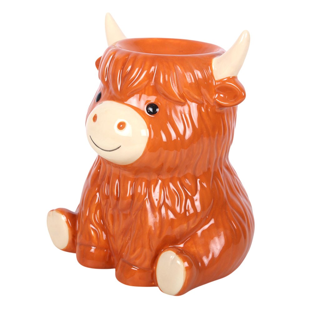 Highland Cow Ceramic Wax Melt and Oil Burner with glossy ginger-brown fur, cream horns, a smiling face and an integrated fragrance dish on top.