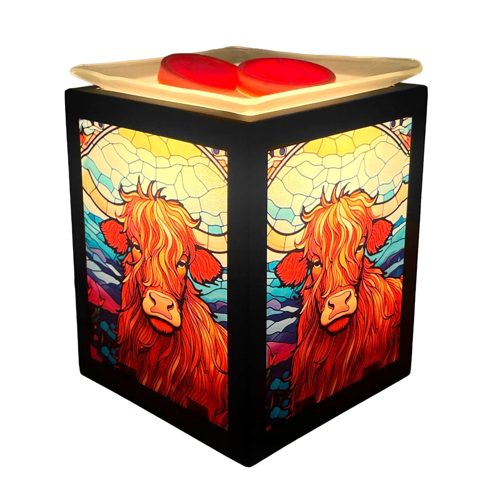 Decorative wax warmer with stained glass design of a cow on a white background