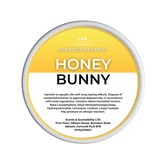 Scented wax melt container labeled 'Honey Bunny' on a green background