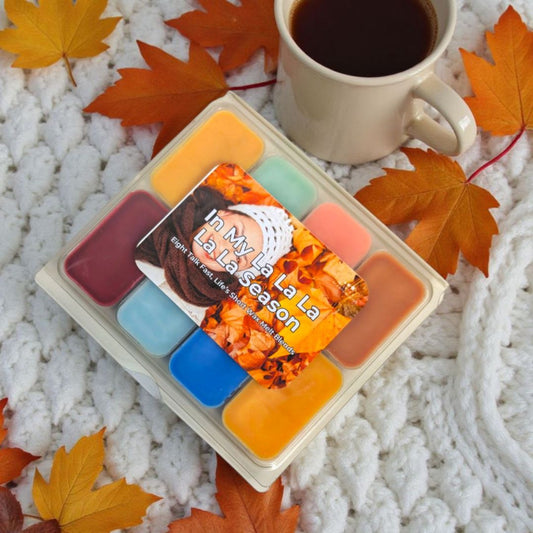 Set of scented wax melts with a coffee cup and autumn leaves on a textured surface