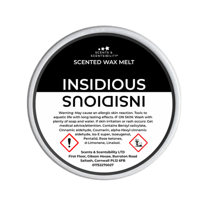 Scented wax melt container with 'Insidious' label on a green background