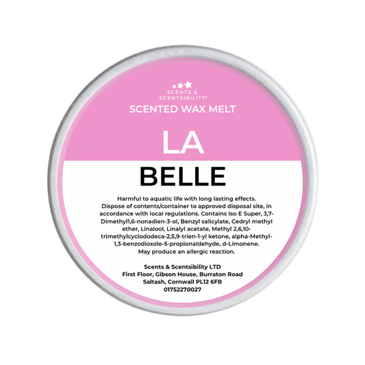Scented wax melt container with pink label on a green background