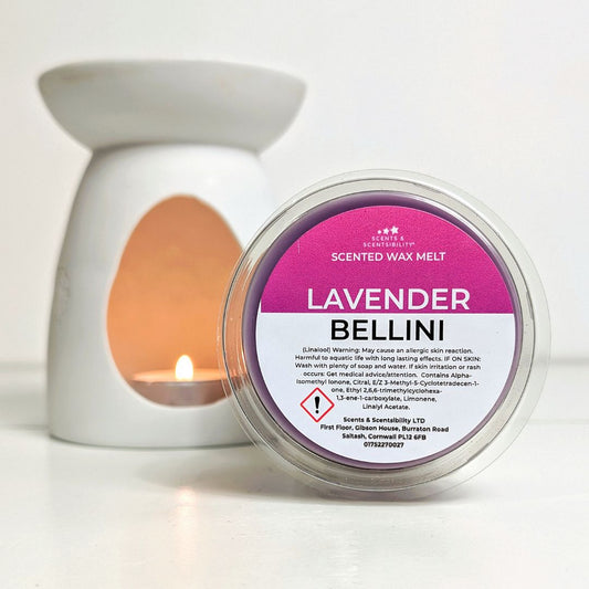 Scented wax melt container labeled 'Lavender Bellini' with a candle in the background.