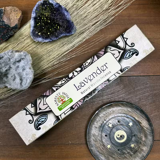 Lavender incense packaging on a wooden surface with decorative elements